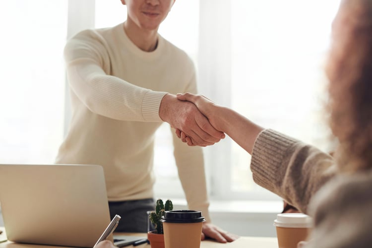 Two people shake hands